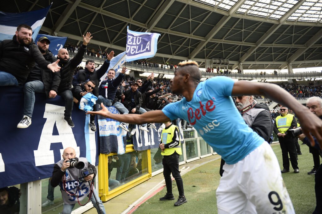 Napoli's Victor Osimhen celebrates with fans after the match