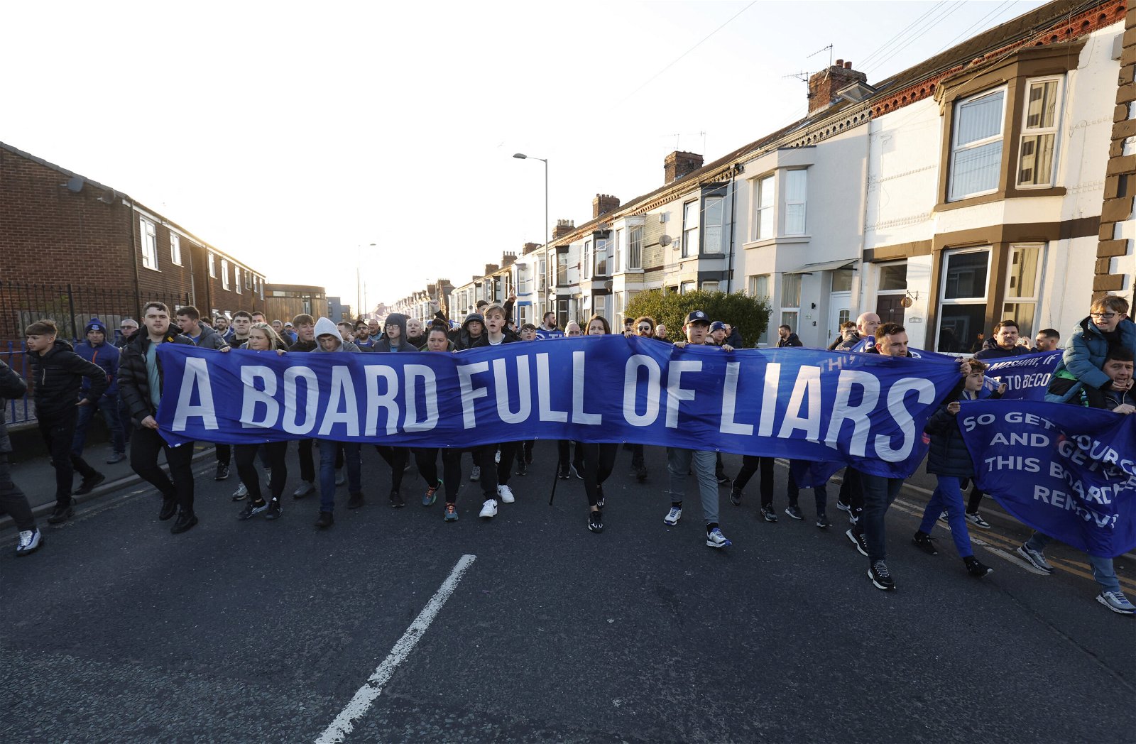 Everton fans display a banner in protest against the ownership of the club outside the stadium before the match
