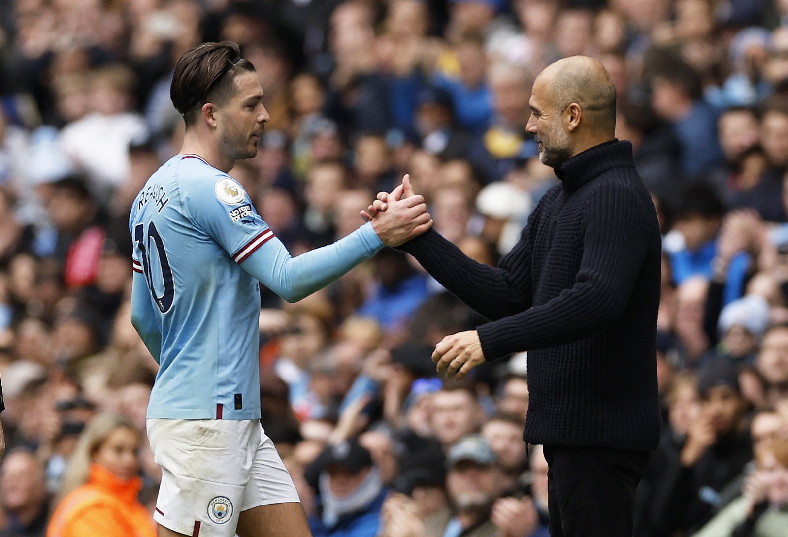 Manchester City's Jack Grealish shakes hands with manager Pep Guardiola after being substituted